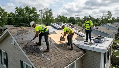 Storm damage restoration team removing water from a Canton, MI home after roof leak flooding